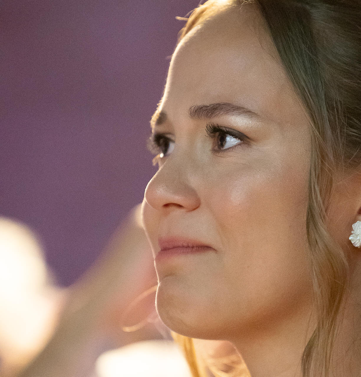 Portrait de profil d’une femme aux boucles d’oreilles, dans la lumière du soir